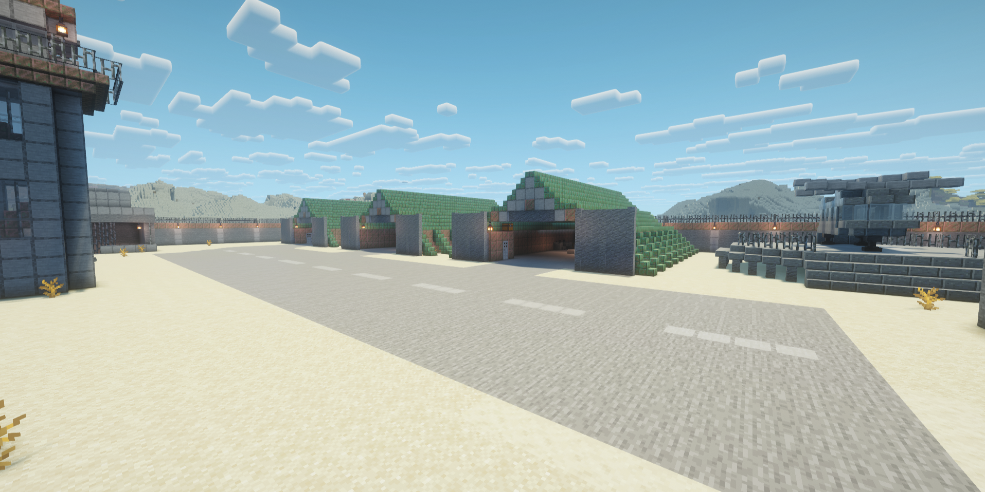 Fenced-in air field with three hangars, a helicopter, a tower, and a runway.