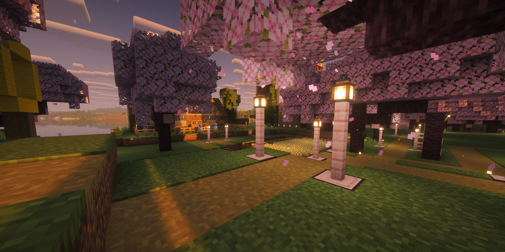 Oak and deepslate house surrounded by cherry trees and lanterns.